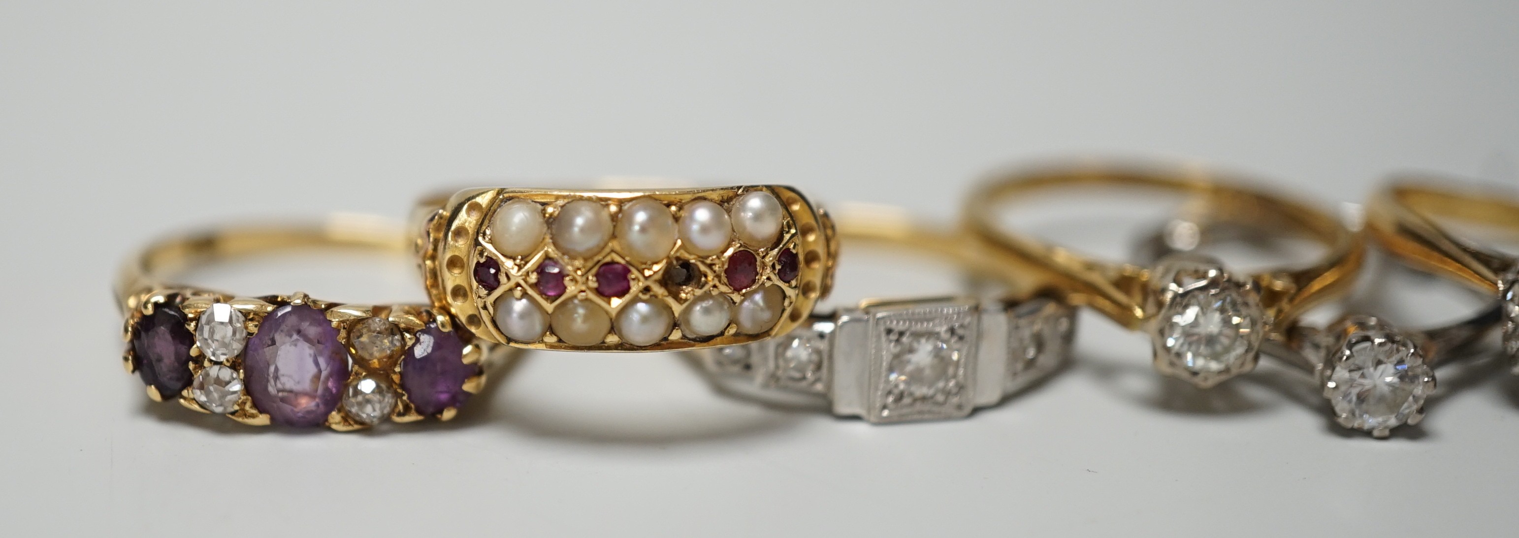 Five assorted 18ct and gem set rings, including 1920's millegrain diamond set, two solitaire diamond rings, sapphire and diamond cluster and amethyst and diamond half hoop (stone replaced and repair) and one other yellow